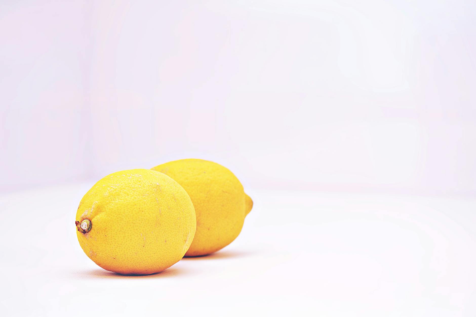 Colorful vibrators and intimate wellness toys arranged on a bright yellow surface