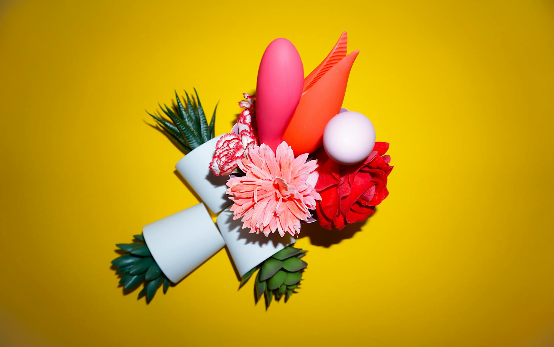 Person holding colorful vibrators against a purple background, representing confidence and choice in sexual wellness